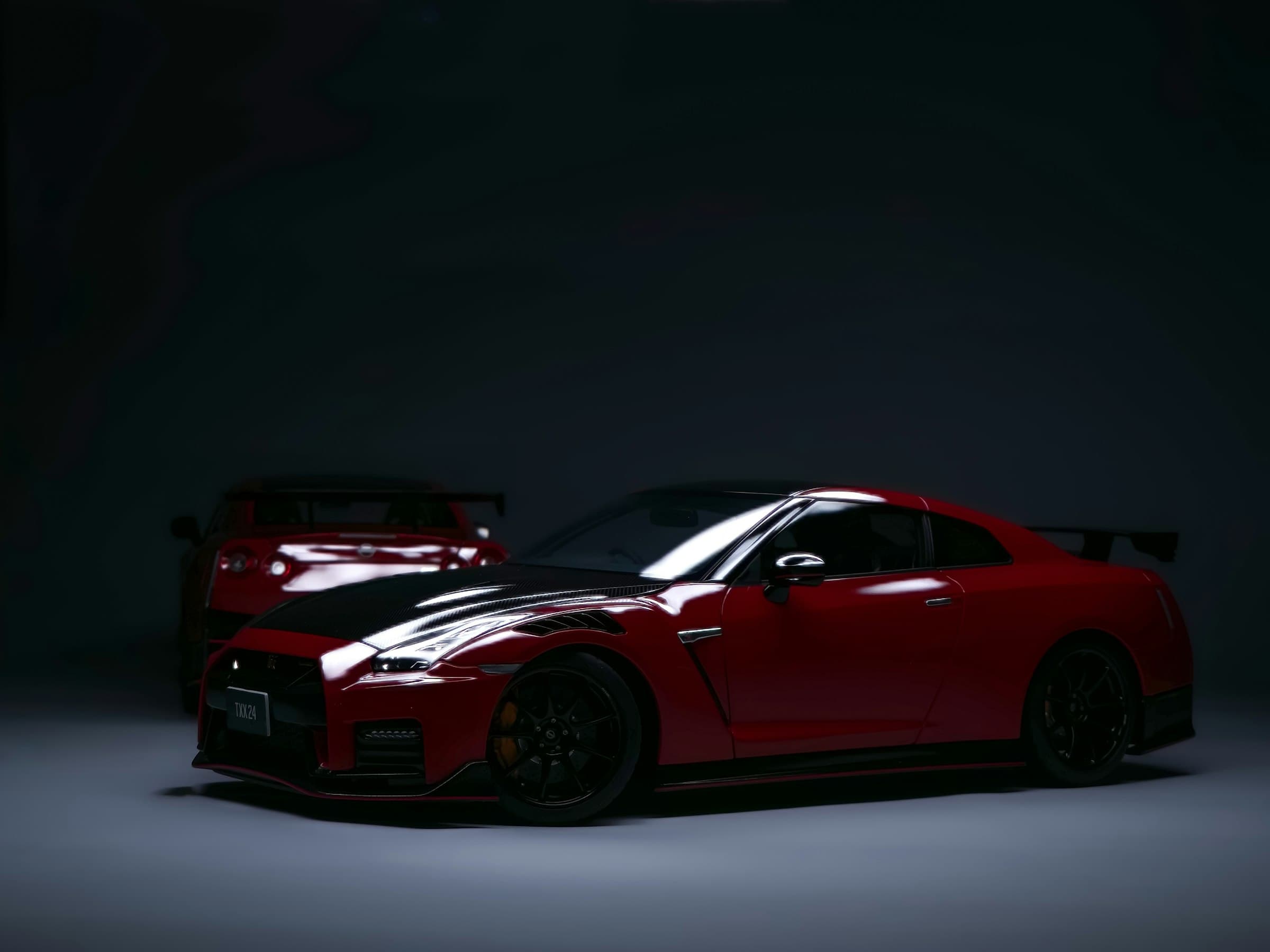 Red supercar on a dark charcoal studio set during an automotive commercial shoot